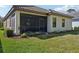 Exterior of the home highlighting the screened porch, well-maintained lawn, and landscaping at 1604 Still River Dr, Venice, FL 34293
