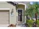 Inviting front entrance with a decorative wreath, well manicured lawn and desert foliage at 1604 Still River Dr, Venice, FL 34293