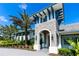 Stunning front entrance showcasing stonework, architectural beams, and lush landscaping at 1604 Still River Dr, Venice, FL 34293