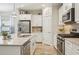 Well-equipped kitchen featuring white cabinetry, stainless steel appliances, and ample counter space at 1604 Still River Dr, Venice, FL 34293