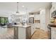Modern kitchen with stainless steel appliances, a center island, and an open floor plan at 1604 Still River Dr, Venice, FL 34293