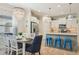 Open-concept living and dining area with modern lighting and eat-in kitchen at 1604 Still River Dr, Venice, FL 34293