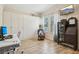 Bright, flex space with hardwood floors, tv and a murphy bed/cabinet at 1604 Still River Dr, Venice, FL 34293