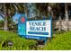Eye-level view of Venice Beach sign with palm trees and landscaping in the foreground at 1604 Still River Dr, Venice, FL 34293