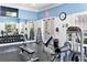 Stay fit in the on-site workout facility with weight-lifting equipment, mirrored walls, and natural light at 1604 Still River Dr, Venice, FL 34293