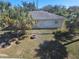 View of the backyard with mature trees, fence, and sitting area at 1666 23Rd St, Sarasota, FL 34234