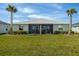 The home has a beautiful backyard, featuring a well-maintained lawn and a screened-in patio for outdoor enjoyment at 17589 Woodland Ct, Punta Gorda, FL 33982