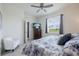 Bright main bedroom with a ceiling fan, tile floors, and a large window at 17589 Woodland Ct, Punta Gorda, FL 33982