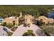 Aerial view of the impressive community clubhouse showcasing its architectural design and manicured landscaping at 181 Portofino Dr, North Venice, FL 34275