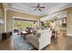 Inviting living room with neutral walls, tile flooring, and an open layout leading to the kitchen and outdoor space at 181 Portofino Dr, North Venice, FL 34275