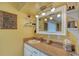 Bright bathroom with a vanity, sink, and decorative mirror, offering a clean and functional space at 2130 Temple St, Sarasota, FL 34239