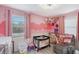 Charming bedroom with pink walls and a cozy layout, designed for a comfort and play at 2130 Temple St, Sarasota, FL 34239