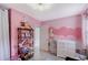 Charming Bedroom with pink walls, ample storage, and playful decor at 2130 Temple St, Sarasota, FL 34239