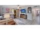 Bright living room with a modern tv, stylish rug, barn door, and comfortable seating arrangement at 2130 Temple St, Sarasota, FL 34239