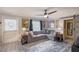 Comfortable living room featuring a large sectional sofa, ceiling fan, and stylish decor with barn door at 2130 Temple St, Sarasota, FL 34239