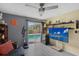Bright living room with ceiling fan, TV, and slider leading to pool area at 2130 Temple St, Sarasota, FL 34239