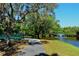 A scenic view of Arlington Park featuring a walking bridge and lake with a fountain and lush trees at 2130 Temple St, Sarasota, FL 34239