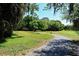 Scenic walking path in the park with mature trees and lush green grass at 2130 Temple St, Sarasota, FL 34239