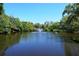 Serene view of a park pond featuring a fountain and natural surroundings at 2130 Temple St, Sarasota, FL 34239