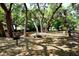 Picnic tables and barbecue grills amidst a canopy of trees at 2130 Temple St, Sarasota, FL 34239