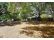 Community playground with swing sets and mature shade trees providing a fun and welcoming environment for children to play at 2130 Temple St, Sarasota, FL 34239
