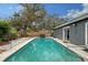 Backyard pool with fence, trees, and beautiful landscaping at 2130 Temple St, Sarasota, FL 34239