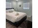 Cozy bedroom with a large bed, two windows for natural light, and a soothing, neutral color palette at 2180 Orchid St, Sarasota, FL 34239