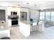 Bright, open kitchen with stainless steel appliances, granite countertops, and a large island with bar seating at 2180 Orchid St, Sarasota, FL 34239