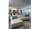 Open-concept living room with a modern white sofa and coastal-themed decor, seamlessly connecting to the kitchen and dining areas at 2180 Orchid St, Sarasota, FL 34239