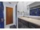 Practical bathroom with dark wood vanity, neutral countertop and coordinated fixtures at 2428 Linwood Dr, Sarasota, FL 34232