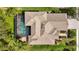 Drone shot showcasing the home's roof, screened-in pool, backyard, and surrounding landscape from above at 2515 130Th E Ave, Parrish, FL 34219