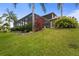 Large backyard featuring a screened-in pool, lush landscaping, and ample space for outdoor activities at 2515 130Th E Ave, Parrish, FL 34219