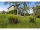 Spacious backyard featuring a screened-in pool, mature trees, and a well-maintained lawn at 2515 130Th E Ave, Parrish, FL 34219