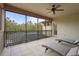 Spacious screened balcony with two chaise lounges overlooks lush greenery and pool at 2515 130Th E Ave, Parrish, FL 34219