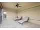 Neutral shaded balcony offers two chaise lounges and ceiling fan for relaxing outdoor space at 2515 130Th E Ave, Parrish, FL 34219