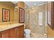 Well lit bathroom with framed mirror, decorative wallpaper, and walk-in glass enclosed shower at 2515 130Th E Ave, Parrish, FL 34219
