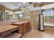 Opulent bathroom boasting a walk-in shower, soaking tub, granite countertops, and beautiful tiling at 2515 130Th E Ave, Parrish, FL 34219