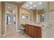 Bathroom featuring elegant finishes, including a marble countertop and wallpaper at 2515 130Th E Ave, Parrish, FL 34219