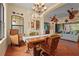 Dining room with wicker chairs, a wood table, and views of the open-concept kitchen at 2515 130Th E Ave, Parrish, FL 34219