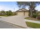 Paver driveway leading to a 3-car garage of a well-maintained home with mature landscaping at 2515 130Th E Ave, Parrish, FL 34219