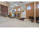 Mirrored home gym with exercise equipment, natural light from windows, and ceiling fan for a comfortable workout at 2515 130Th E Ave, Parrish, FL 34219
