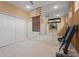 Well-equipped home gym featuring mirrors, neutral paint, exercise equipment, and bright lighting at 2515 130Th E Ave, Parrish, FL 34219