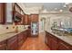 Gourmet kitchen featuring granite countertops, stainless steel appliances, and custom wood cabinets at 2515 130Th E Ave, Parrish, FL 34219