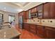 Modern kitchen showcasing stainless steel appliances, wood cabinetry, and granite countertops at 2515 130Th E Ave, Parrish, FL 34219