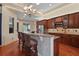 Kitchen with a breakfast bar, modern appliances, wood cabinetry, and a view to the backyard at 2515 130Th E Ave, Parrish, FL 34219
