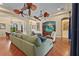 A spacious living room features wood floors, ceiling fans, a blue couch, and stylish decor at 2515 130Th E Ave, Parrish, FL 34219