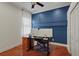 Home office with hardwood floors, a white accent wall, and two computer monitors at 2515 130Th E Ave, Parrish, FL 34219