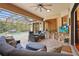 Comfortable covered patio featuring stylish furniture, a ceiling fan, and a view of the pool at 2515 130Th E Ave, Parrish, FL 34219