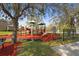 Community playground equipment, including slides and climbing structures, is surrounded by trees and open space at 2515 130Th E Ave, Parrish, FL 34219
