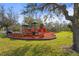 Community playground equipment, including slides and climbing structures, is surrounded by trees and open space at 2515 130Th E Ave, Parrish, FL 34219